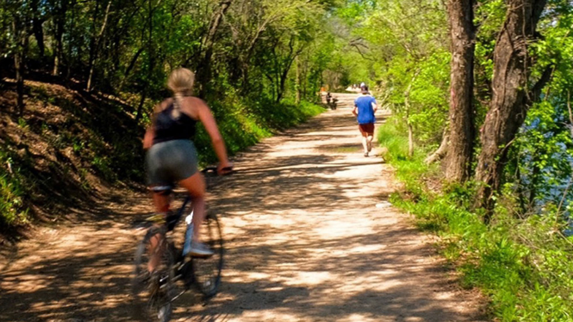 People running and biking on an outdoor recreation trail
